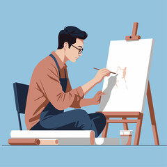 A man with glasses and an apron sits on the floor, focused on painting on an easel with a brush.