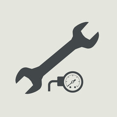A wrench and a pressure gauge, essential tools for mechanical work and maintenance.