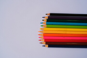 A row of colorful pencils on white background
