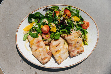 Grilled chicken breast with vegetables and herbs