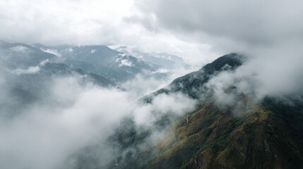 Fototapeta premium Mountain Range Shrouded In Mist And Clouds. Serene And Majestic Natural Landscape