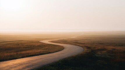 Winding Road Through Misty Landscape At Sunrise. Serene Journey Into The Horizon