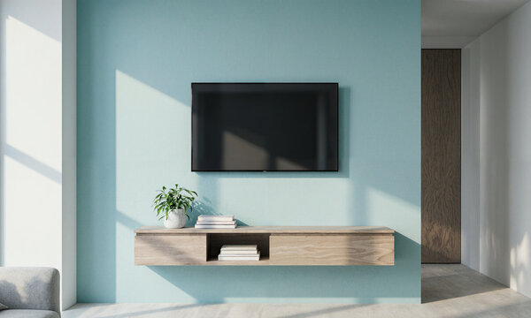 Coastal Blue Interior - A pale aqua wall supporting a mounted TV above a floating console, styled with books