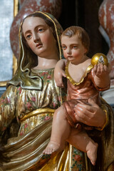 Statue (19th century) of Blessed Virgin Mary holding baby Jesus Christ in her arms.