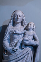 Stone statue (19th century) of Blessed Virgin Mary holding baby Jesus Christ in her arms.