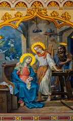 Fototapeta premium Fresco (1912) of Holy family: Jesus infant, Virgin Mary and St Joseph in the workshop of Joseph the carpenter.