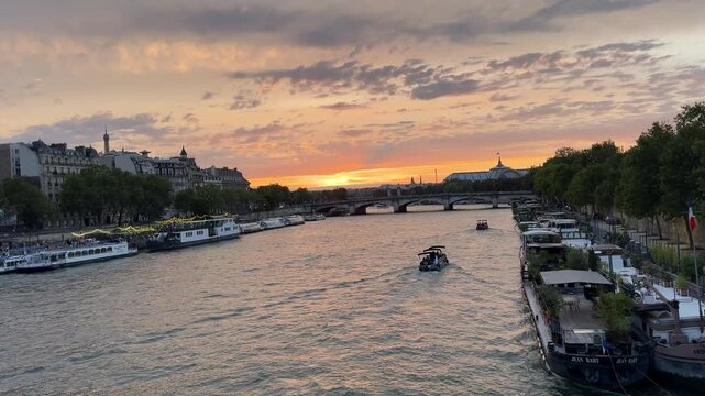 Scenic view of the River Seine in Paris, France, flanked by historic Parisian buildings, bridges, and waterfront streets, ideal for travel, cityscape, and European heritage footage.