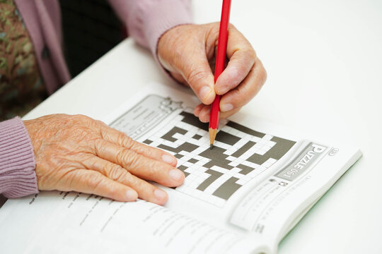 Bangkok, Thailand - May 15, 2022 elderly woman playing sudoku puzzle game.