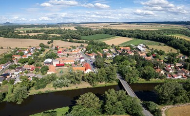 Počedělice village near Louny and Žatec, Czechia, with hop production field, aerial drone panorama