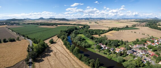 Počedělice village near Louny and Žatec, Czechia, with hop production field, aerial drone panorama