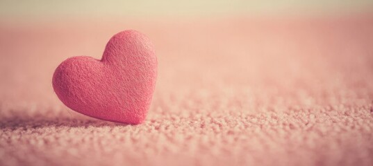 Fototapeta premium Cute Pink Felt Valentine s Heart Craft Decoration on Fuzzy Knit Background for Romantic Occasions