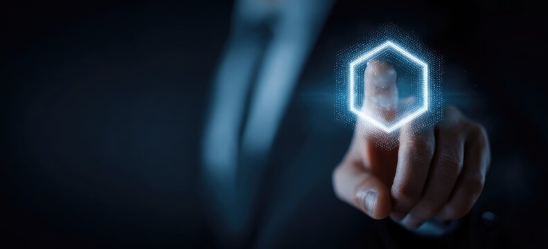 A person in a suit uses a glowing hexagon interface, emphasizing technology and interaction
