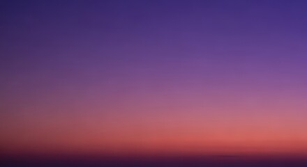 A tranquil abstract background of the twilight sky with a smooth gradient from deep purple to warm orange