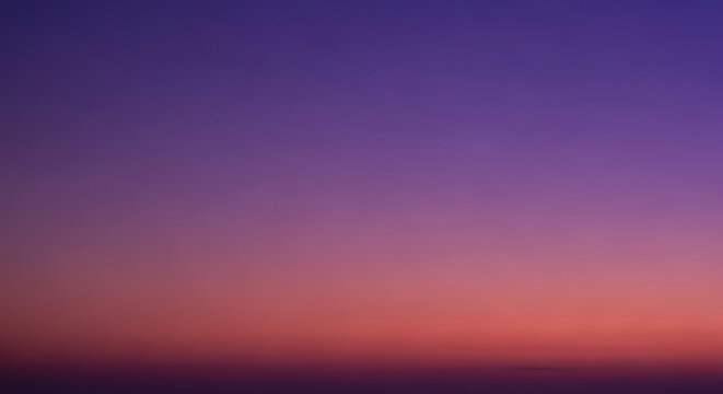 A tranquil abstract background of the twilight sky with a smooth gradient from deep purple to warm orange