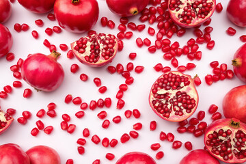 Fresh Pomegranates Still Life: Ruby Red Seeds, Whole & Halved Fruits on White Background - Healthy Eating, Antioxidant Rich, Vibrant Food Photography