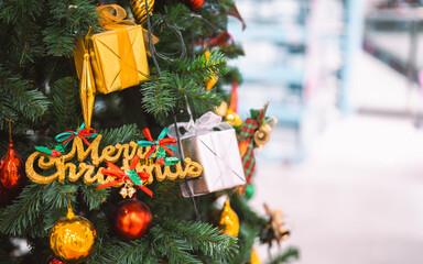A festive Christmas tree decorated with colorful ornaments, shiny baubles, gift boxes, and holiday ribbons, creating a warm seasonal atmosphere perfect for celebration themes and winter holiday design