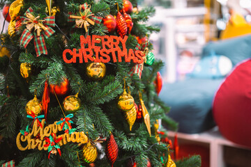 A festive Christmas tree decorated with colorful ornaments, shiny baubles, gift boxes, and holiday ribbons, creating a warm seasonal atmosphere perfect for celebration themes and winter holiday design