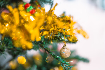 Closeup garland Christmas tree decoration,red,gold,silver ornament with bokeh background. Perfect holiday sales, winter celebration, festive seasonal promotions, marketing, shopping with copy space