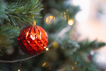 Closeup garland Christmas tree decoration,red,gold,silver ornament with bokeh background. Perfect holiday sales, winter celebration, festive seasonal promotions, marketing, shopping with copy space