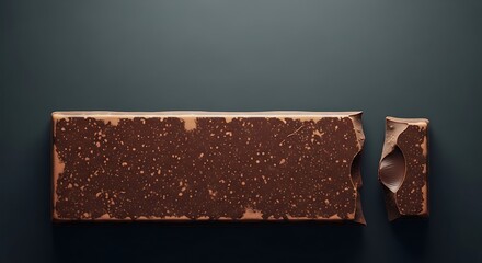 Indulgent chocolate bar with a bite taken, on moody background