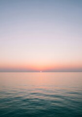 Subtle sunrise over the ocean with soft, tranquil water ripples
