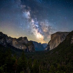 A breathtaking night scene features the Milky Way galaxy stretching across a starry sky above majestic rock formations. The valley is filled with trees