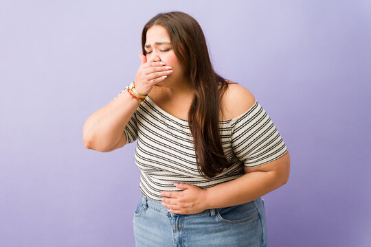 Curvy woman feeling nauseous having stomach ache