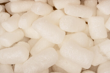 Pink and white box filler as a background. Top view.