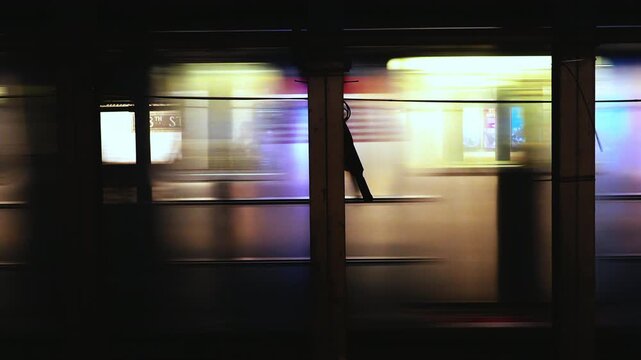 Fast moving subway train passing through New York City underground station urban transit scene