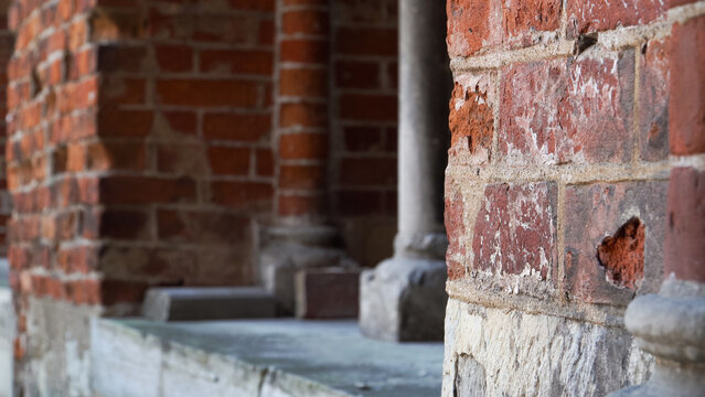 Close-up of Riga Cathedral ancient red brick outdoors facade: historical sample of medieval architecture in Latvia. It epitomizes traditional medieval building facade texture beauty.