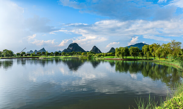 Beautiful lake water reflection with green trees and mountain scenery.