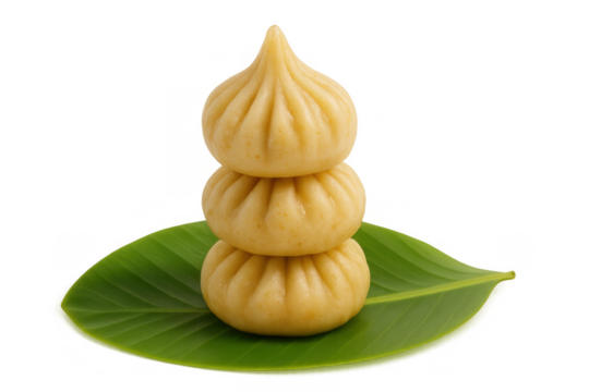 Modak stack, traditional steamed indian sweet dumplings, placed on a banana leaf for ganesh chaturthi celebrations and offerings