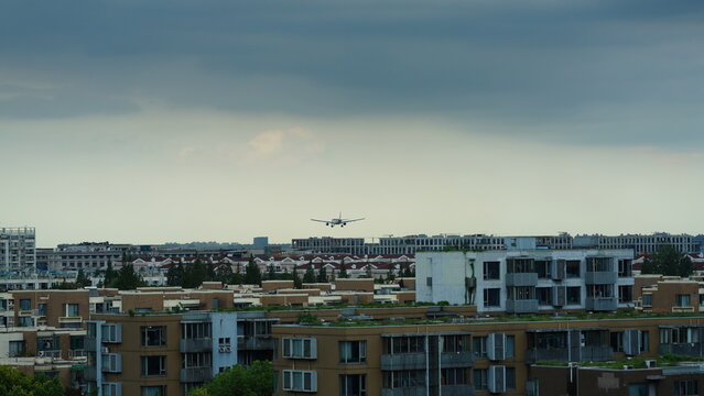 One airplane was landing with the city skyline as background