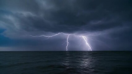 Dramatic lightning bolt strikes the dark open ocean under a cloudy, stormy sky at night during a summer thunderstorm - Powered by Adobe