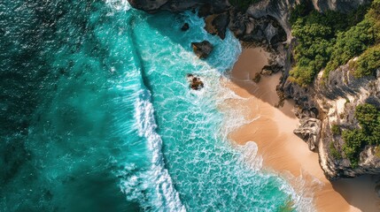Aerial View of Turquoise Waves Crashing on Coastal Cliff with Sandy Beach Surrounded by Lush Greenery During Bright Summer Day