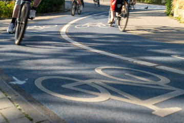 Close Up of a Bicycle Road. Blue Bike Lane With the Bicycles passing on the white symbol of a bike in Konstanz, Germany.