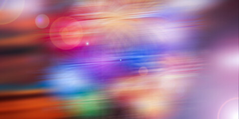 Vibrant abstract blurry lights streaking across a dark background with bokeh effects