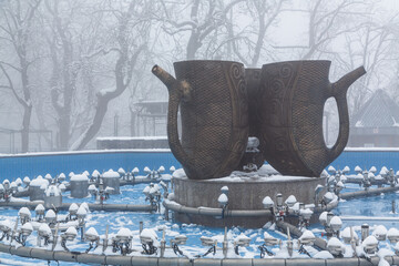 Smirnovsky Fountain with two large cups that are also drinking halls in a spa park in resort town of Zhrlrznovodsk in winter, Russia