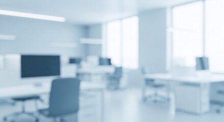 Blurred modern office interior with desks and computers out of focus