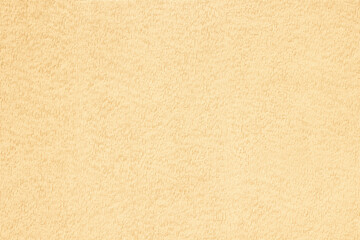 Beige pastel on plaster surface. Colored background