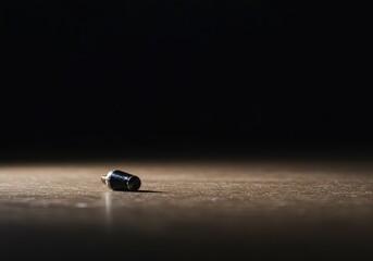 A blurry background emphasizes a small, sharp, isolated object resting on a plain surface. The deep depth of field creates a sense of peaceful quiet ,surface ,out of focus ,quiet