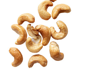 A cluster of roasted cashew nuts scattered on a black background