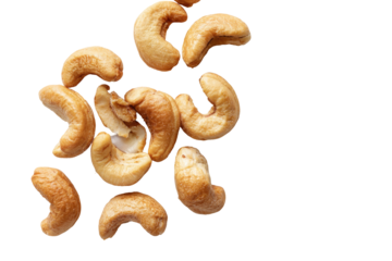 A cluster of roasted cashew nuts scattered on a black background