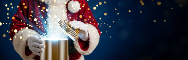 Santa Claus opening magical gift box with blue beams and glitter. Hands in white gloves holding striped present with surprise. Christmas and New Year holiday banner