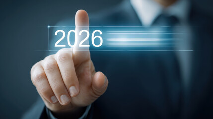 Businessman pressing futuristic 2026 touch interface with glowing light streaks conveying innovation and planning for future strategy