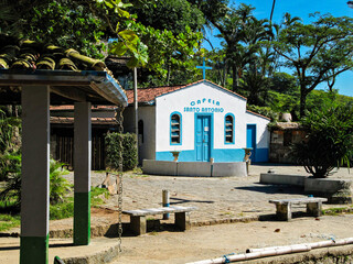Historic Coastal Chapel with White Fa&ccedil;ade and Blue Doors in Ilhabela, Brazil