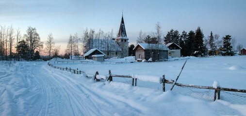 View of the village and stone church on a frosty winter day