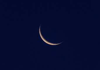 A crescent moon in the night sky