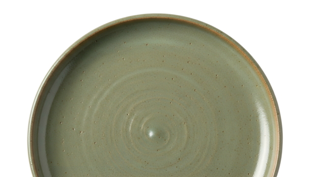 Close-up of a rustic, green ceramic plate with a textured surface, set against black