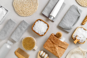 Naklejka na ściany i meble Top view Spa or bath accessories on grey background. Sea salt, cotton towels, natural brushes, wooden massagers, washcloth, relaxation, self-care routines, or eco-friendly beauty products, above